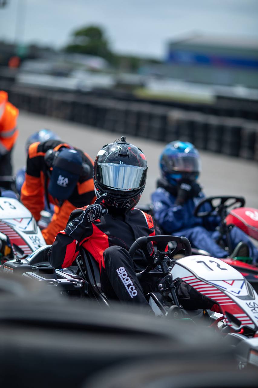 Kseniia showing number one with visor down